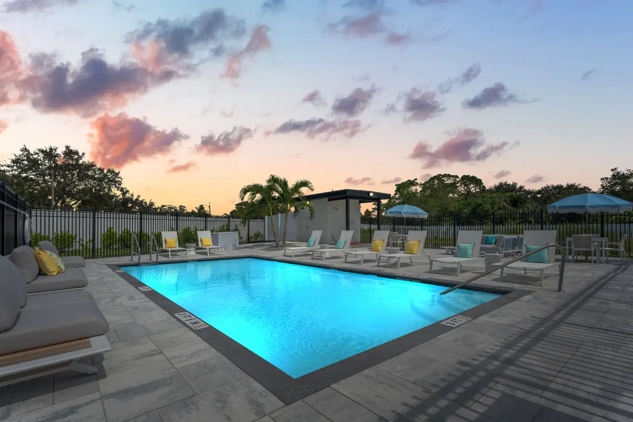 Resort-style pool lit at twilight inside the gated community at Latitudes in the Park, Pinellas Park FL