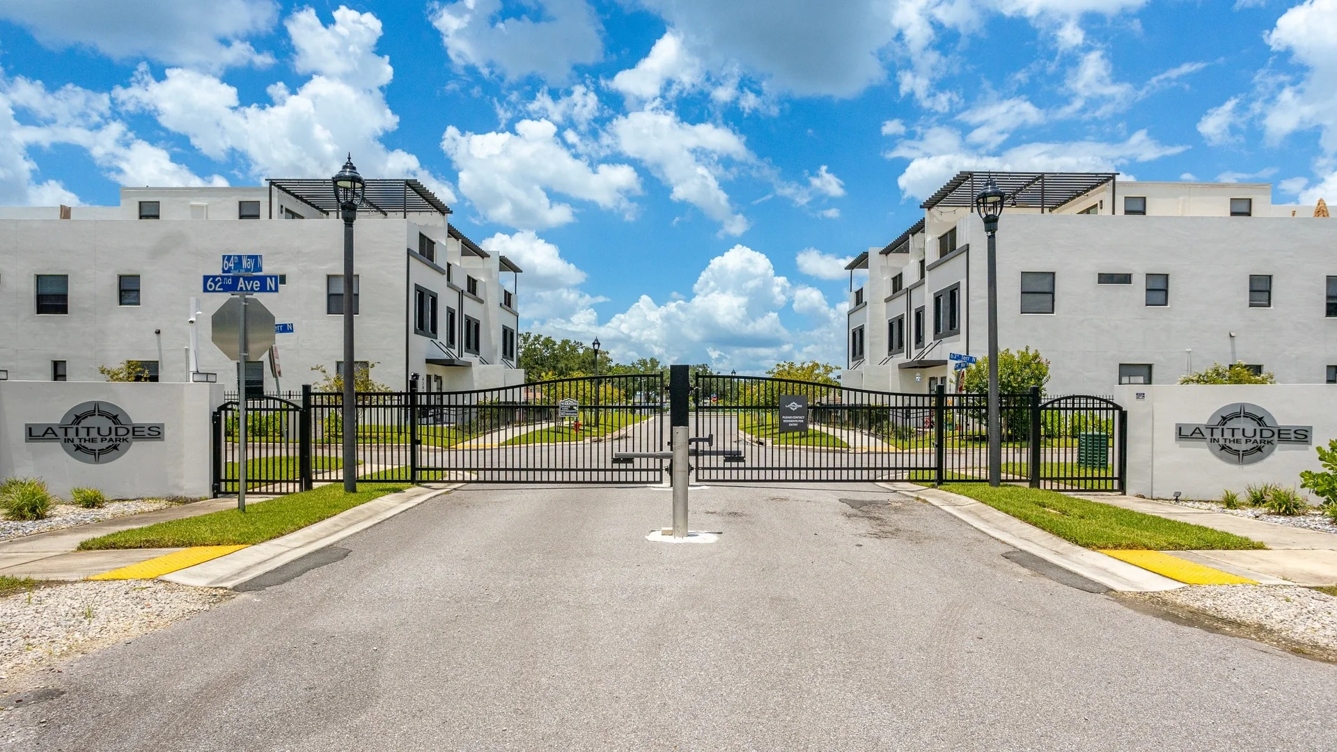 Front elevation and landscaped gated entry drive at Latitudes in the Park, Pinellas Park FL